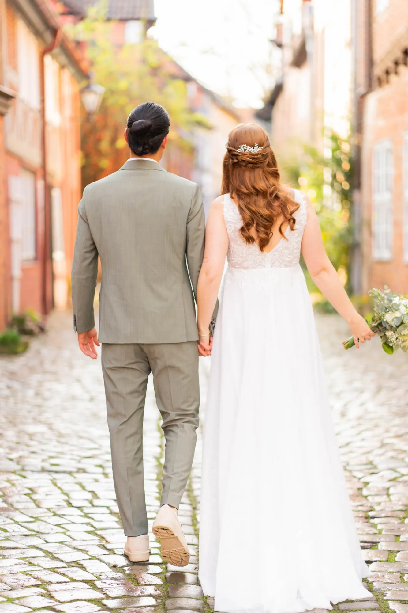 Brautpaar Hand in Hand in einer historischen Gasse